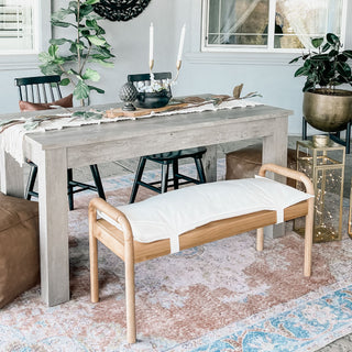 Outdoor dining room with a wooden bench, table, and chairs.