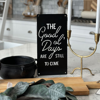 Decorative sign with motivational quote in a kitchen setting
