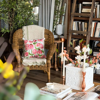 Cozy living room with wicker chair, floral pillow, and decorative elements. European Cottage Steal It Box