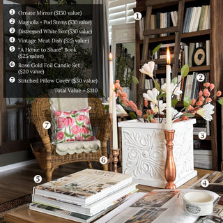 Living room with a wicker chair, books, and decorative items with itemized values. EUROPEAN COTTAGE: THE ESSENTIALS COLLECTION BY STEAL IT BOX