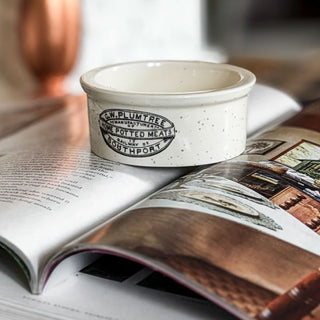 Small white ceramic bowl with a logo on an open book. European Cottage Steal It Box