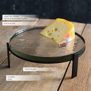 Glass riser stand styled with candles and greenery