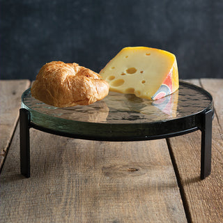 Close-up of metal-leg glass pedestal stand