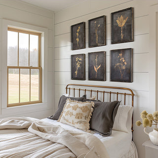 Farmhouse style botanical gallery wall set with weathered black frames and golden florals