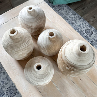 Top view of five natural wooden vases