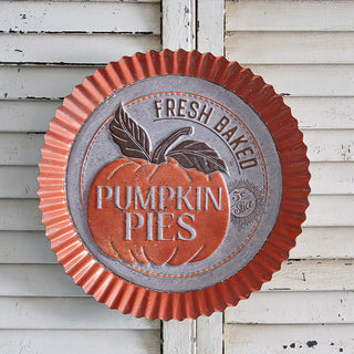 Close-up of distressed metal pumpkin pie sign, vintage fall wall decoration