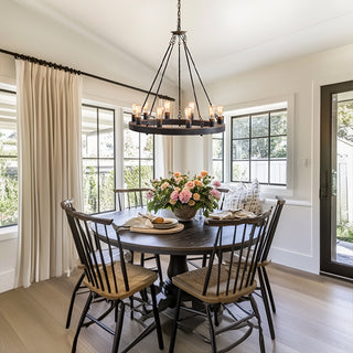 Rustic round chandelier over farmhouse dining table