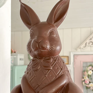 Chocolate bunny with a bow tie in a decorative room