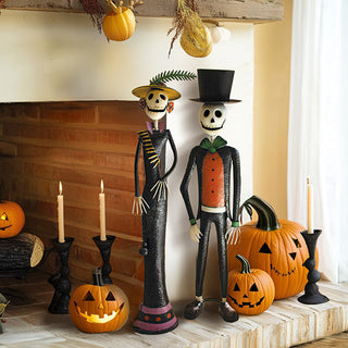 Halloween fireplace decor featuring metal skeleton couple figurines