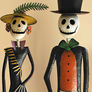 Close-up of metal skeleton couple figurines