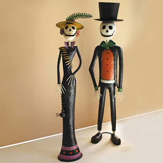Pair of tall metal skeleton figurines