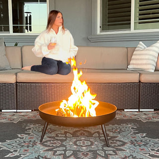 Outdoor fire pit with flames patio setting