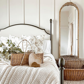 Arched gold mirror above farmhouse bedroom decor