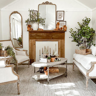 Farmhouse living room styled with tall arched mirror