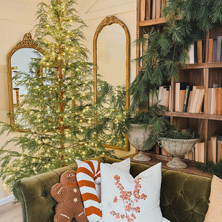 Holiday living room decor with gold arched mirrors