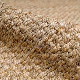 Close-up of a woven jute rug with a natural beige color.