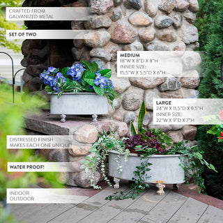 Galvanized metal planters with evergreen and berry holiday arrangement on stone outdoor hearth