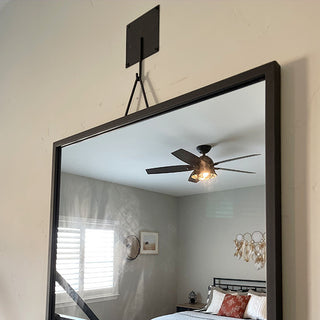 Close-up black metal mirror wall mount bracket