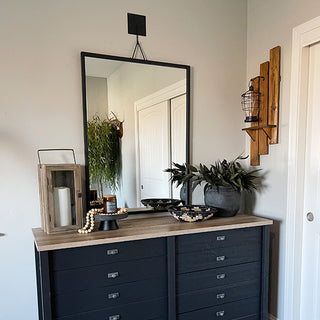 Rustic black framed mirror over dresser