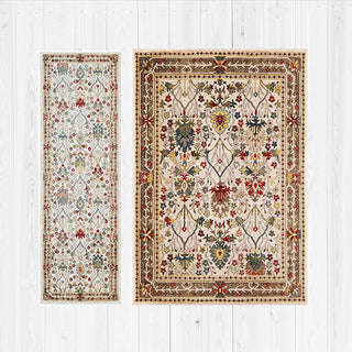 Two floral-patterned rugs on a white wooden floor.