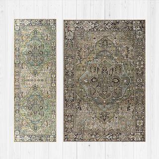 Two sage green patterned rugs on a white wooden floor.