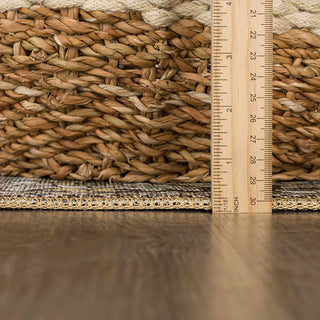 Woven mat with a ruler for scale on a wooden floor