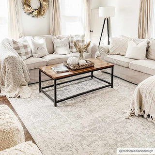 Cozy living room with beige sofas, a wooden coffee table, and decorative elements.