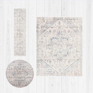 Set of three area rugs with geometric patterns on a light wooden floor.