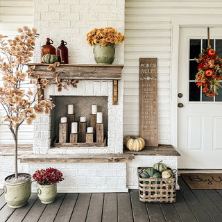 Fall farmhouse porch decor with green metal planters