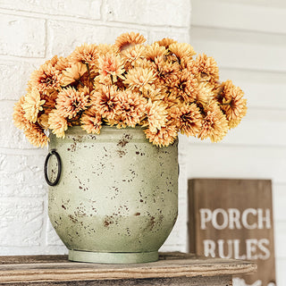Distressed green metal planter with faux fall flowers