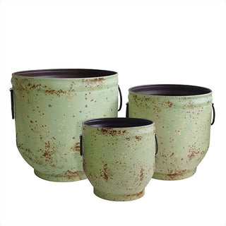 Distressed green metal planters set on white background


