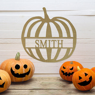 Custom pumpkin metal wall sign with “Smith” family name, displayed with carved jack-o’-lanterns