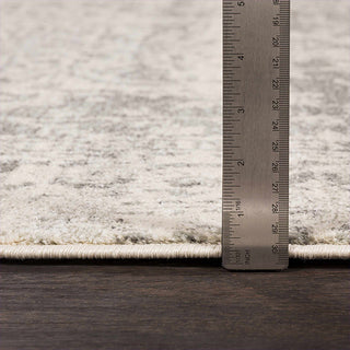 neutral toned area rug with a metal ruler for size reference