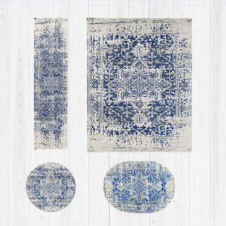 Set of blue and white patterned rugs on a light wooden floor.