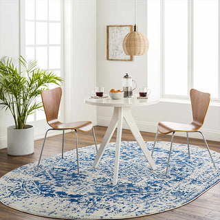 Dining room with a round blue and white patterned rug, wooden chairs, and a small table.
