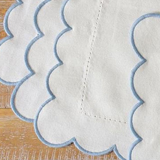 Hemstitched cotton placemat with blue scalloped edge
