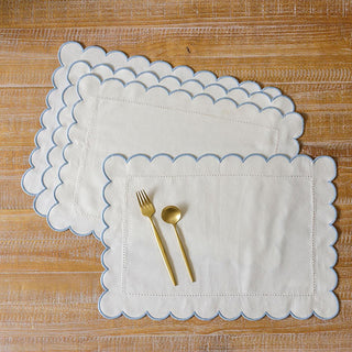 Set of four scalloped cotton placemats blue trim
