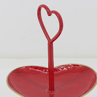 Heart handle detail on red two-tier serving stand
