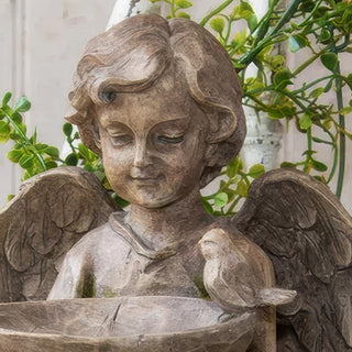 Close-up of angel statue face showing distressed stonepowder resin finish and detailed features