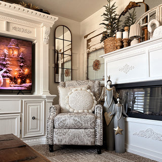 Large statement angel figurines with gold wings and heart star ornaments in elegant living room holiday display