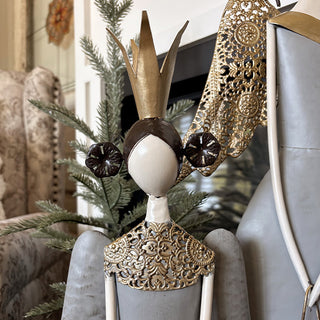 Close-up of angel figurine gold crown and intricate filigree wing detail with ornate metalwork craftsmanship