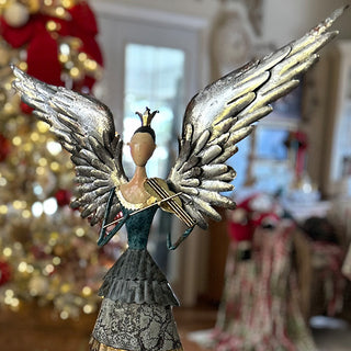 Detailed view of teal and silver metal angel with crown, showing layered dress and dimensional wing construction