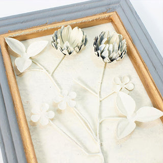 Dimensional white floral wall art with distressed frame