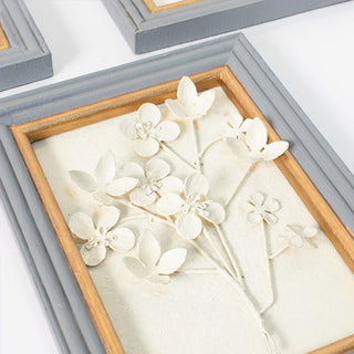 Textured floral wall decor with raised metal flowers