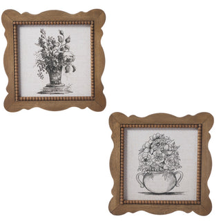 Two framed black and white floral illustrations with wooden frames on a white background.