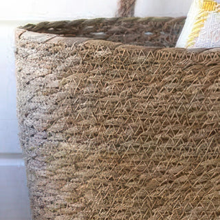Close-up of natural woven seagrass basket texture showing detailed diagonal weave pattern and construction