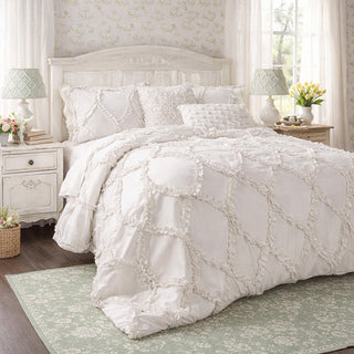 White cottage chic comforter set with diamond ruffle pattern on bed with shabby chic nightstands and green botanical rug