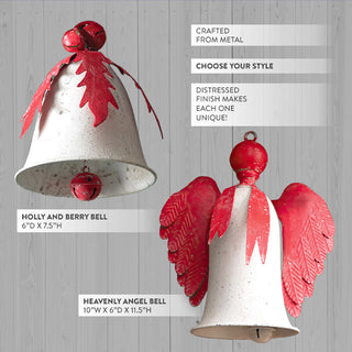 Two farmhouse style metal bell ornaments on white wood background - smaller holly berry bell and larger angel bell with detailed wing design