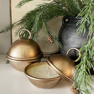 Brass cloche candle with evergreen winter styling