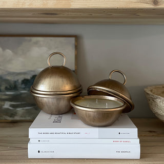 Brass cloche candles styled on stacked books